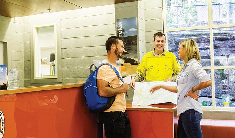 NPWS staff helping visitors at Royal National Park visitor centre. Photo: Simone Cottrell/DPIE