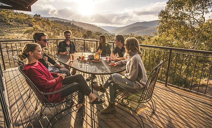Group of friends on the balcony of Creel Lodge at sunset. Photo: Boen Ferguson/OEH