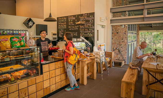 A woman orders a snack at the counter at Jenkins Hall Cafe, in Lane Cove National Park. Photo: John Spencer/OEH