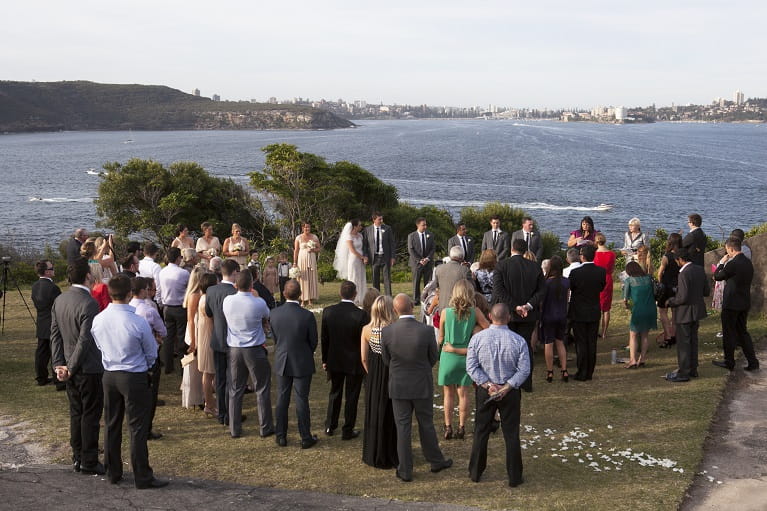 Bride and groom celebrate wedding at Middle Head, Sydney Harbour National Park. 